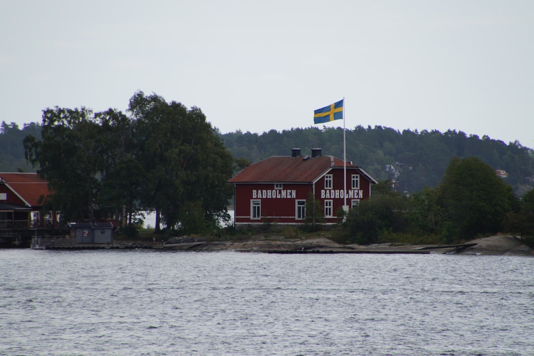 brown wooden house near body of water