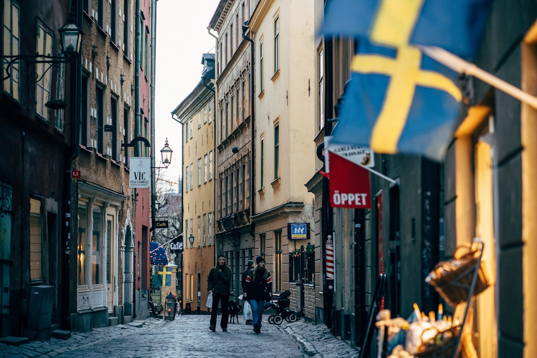 two men walking on alley with flags