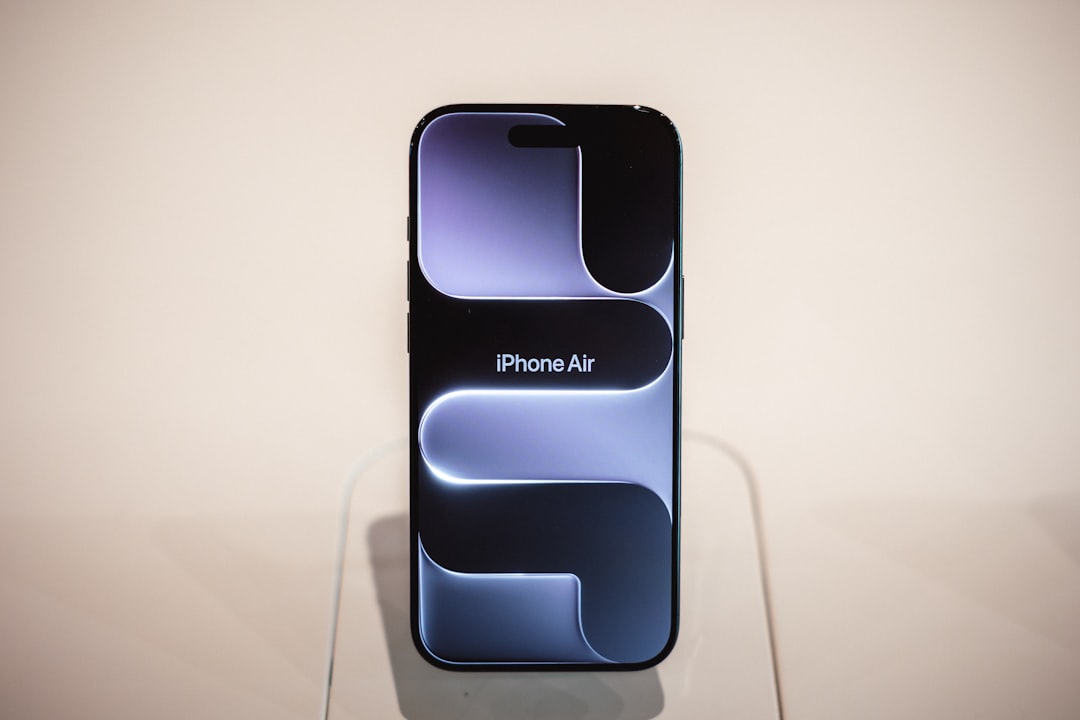 Modern smartphone displaying abstract purple design on screen.